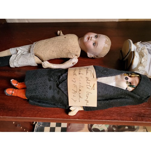 134 - A Ridings Craft bisque head doll with fixed blue eyes and cloth body, 40cm, a bisque head doll with ... 