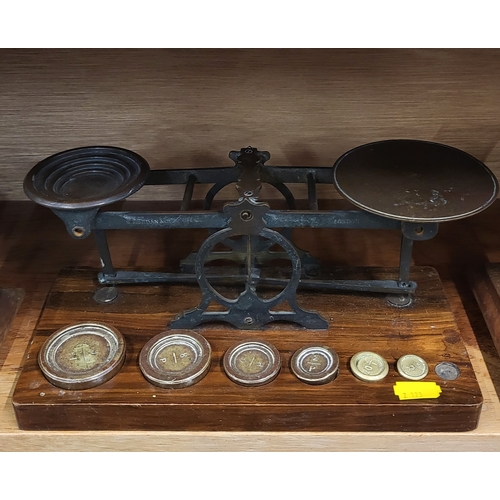 103 - A set of four vintage weighing scales, with brass weights, on wooden base.