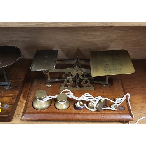 103 - A set of four vintage weighing scales, with brass weights, on wooden base.