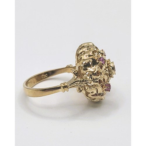 387 - A yellow metal cocktail ring, set with five round-cut rubies, in an openwork mount, indistinctly mar... 