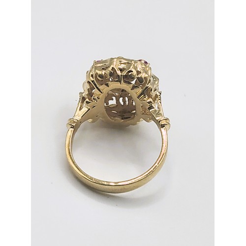 387 - A yellow metal cocktail ring, set with five round-cut rubies, in an openwork mount, indistinctly mar... 