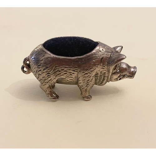 237 - A novelty silver pin cushion in the form of a pig, with blue velvet back, and engraved decoration.