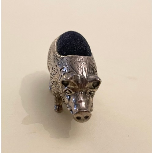 237 - A novelty silver pin cushion in the form of a pig, with blue velvet back, and engraved decoration.