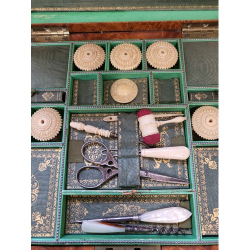 97 - A late 19th / early 20th century green lined sewing box, containing various sewing paraphernalia, to... 