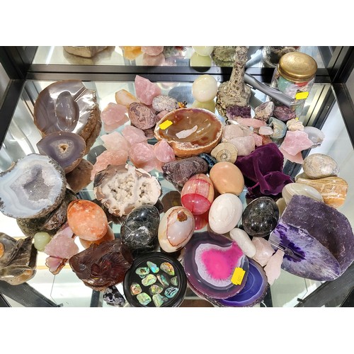 121 - A group of various rocks and minerals, including agates, quartzes, and onyx, some carved, some natur... 