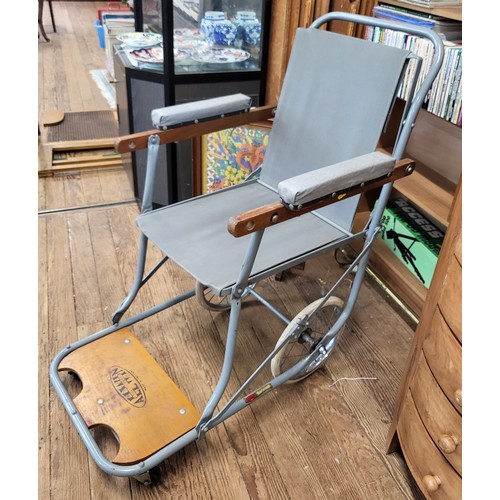 124 - A vintage wood framed bedrest with rattan back, together with a wheelchair/ carry chair