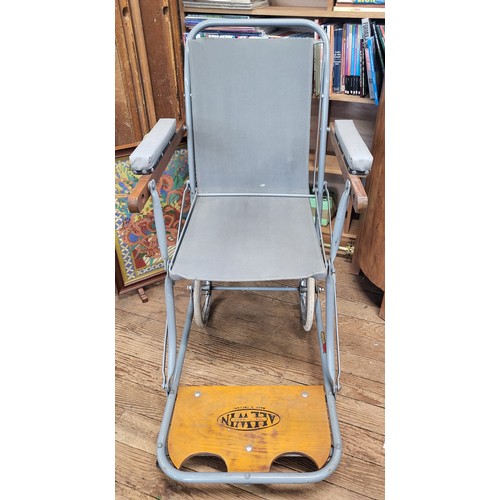 124 - A vintage wood framed bedrest with rattan back, together with a wheelchair/ carry chair