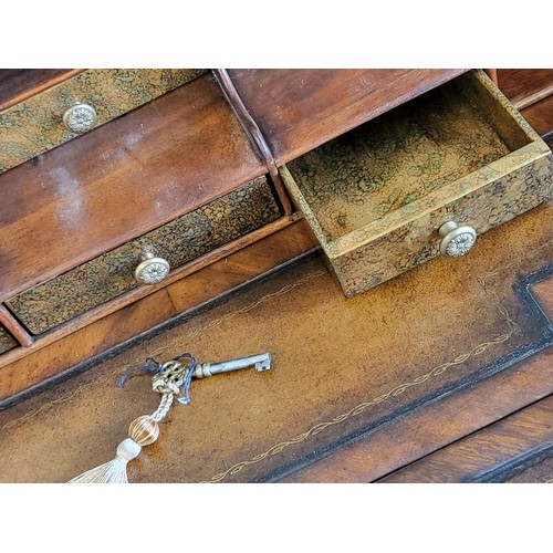 41 - A  Theodore Alexander eglomise desk with cabriole legs and brass finials, and a crafted brass galler... 