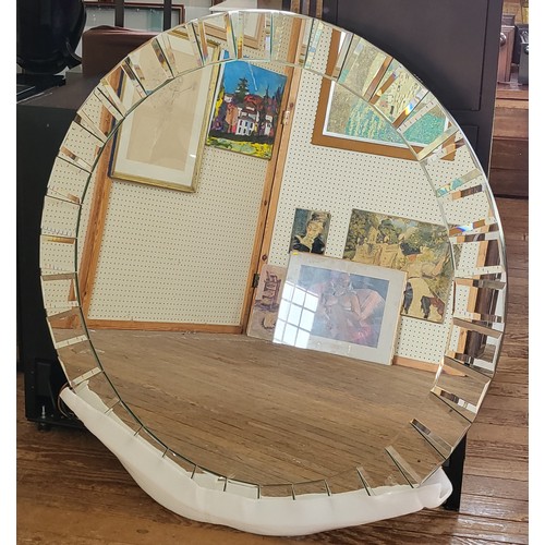 54 - A large circular mirror with bevelled rectangular details around the circumference. 110cm diameter