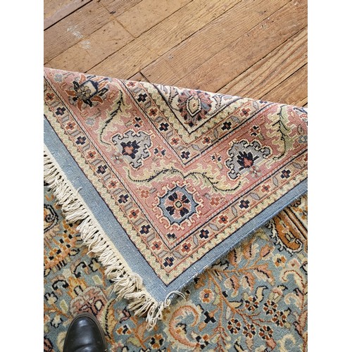 72 - A pale blue, pink and cream rug. 280cm x 188cm.