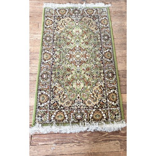 73 - A green rug. 170cm x 92cm.