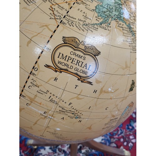 26 - A vintage Cram's Imperial world globe with meridian ring on a turned baluster support, with four out... 