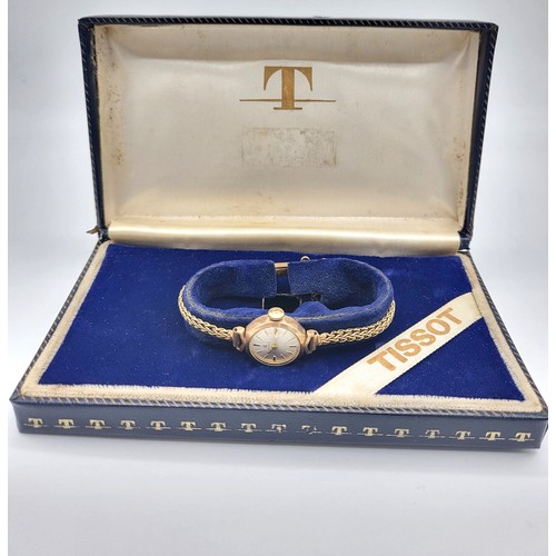 398 - A Tissot 9ct gold ladies watch on an articulated bracelet and safety chain in the
original presentat... 