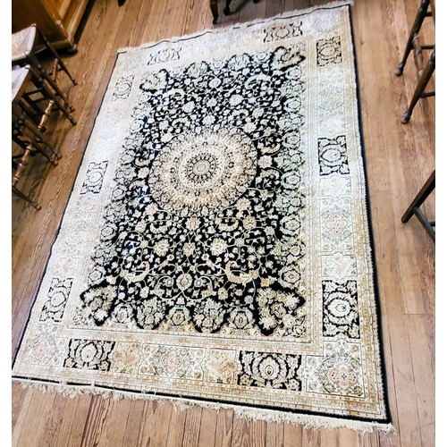 75 - A large cream and black ground rug, with central medallion on elaborate decoration, bordered and fri... 