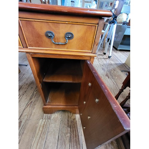 36 - A wooden pedestal desk, with green leather top, in three parts. Left cabinet has three drawers, righ... 