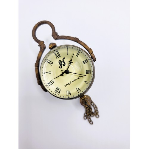 71 - A brass and glass desk ball clock.