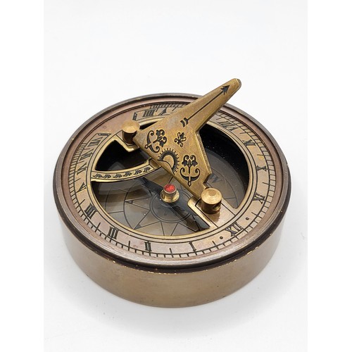 72 - A novelty brass-cased sundial and compass.