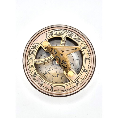 72 - A novelty brass-cased sundial and compass.