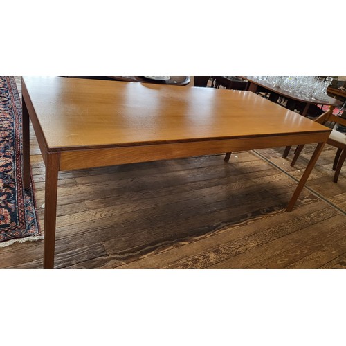 62 - A mid-20th century teak dining table, of rectangular design, supported on four straight legs (screw ... 