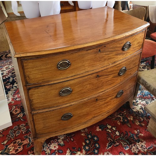 64 - A mahogany bow-front chest of three drawers, brass handles, supported on bracket feet. 85cm x 94cm x... 