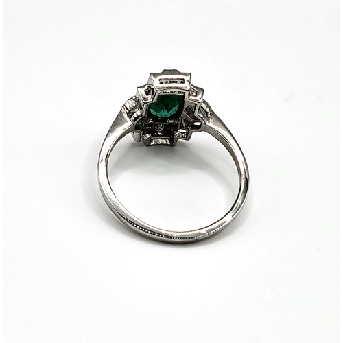 373 - A platinum, diamond, and emerald Art Deco style ring, set with a mixed oval-cut emerald of approxima... 