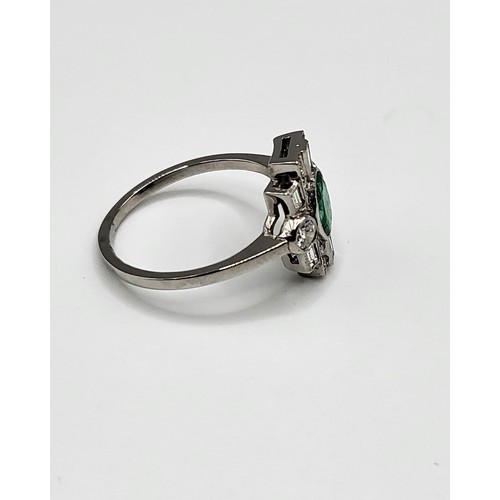 373 - A platinum, diamond, and emerald Art Deco style ring, set with a mixed oval-cut emerald of approxima... 