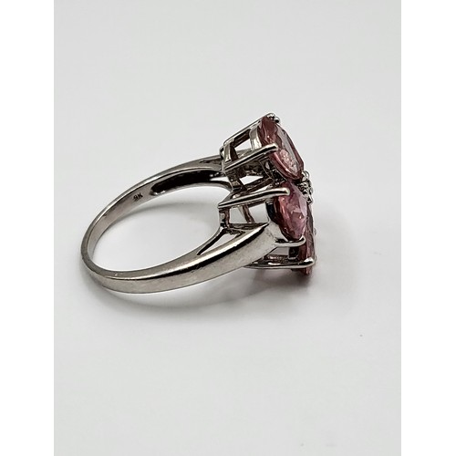 382 - A 9ct white gold and pink tourmaline floral cluster ring, set with five mixed pear-cut petals, centr... 