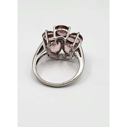 382 - A 9ct white gold and pink tourmaline floral cluster ring, set with five mixed pear-cut petals, centr... 