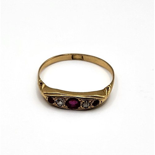 383 - An 18ct yellow gold, diamond, and ruby ring, set with a larger round-cut ruby, two old-cut diamonds,... 