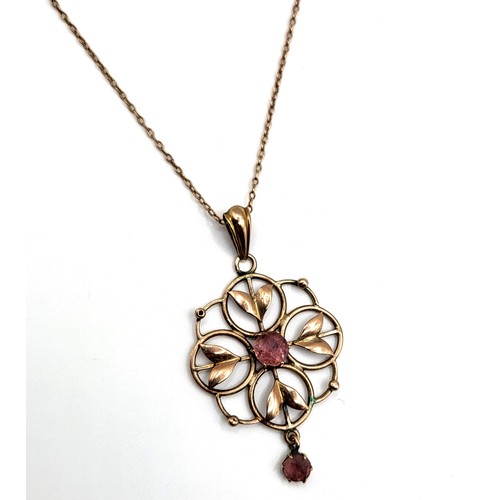 384 - A late 19th / early 20th century Art Nouveau pendant, the quatrefoil openwork mount centred with a m... 