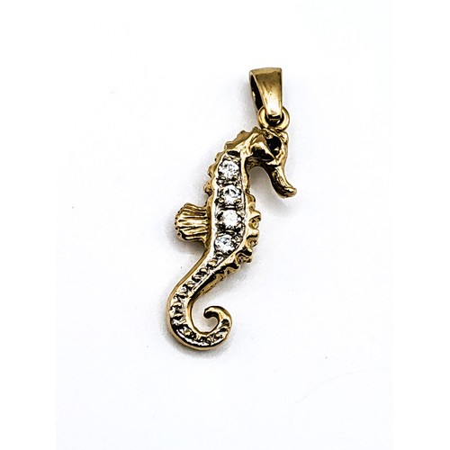 386 - A 9ct yellow gold seahorse pendant, set with blue and white stones, 3.4 cm long including suspension... 