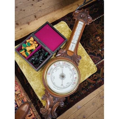 70 - An Aneroid Barometer in a carved mahogany case, early 20th century.  Also to include a modern footst... 