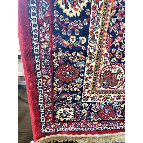 77 - A fine Persian rug, central medallion design, blue, red and cream ground, bordered and fringed. 184c... 