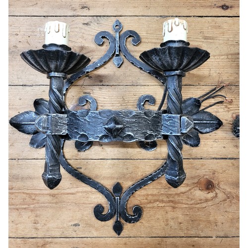 37 - Four matching metal wall sconces (Medieval Italian castle style), 45cm high, 40cm width.