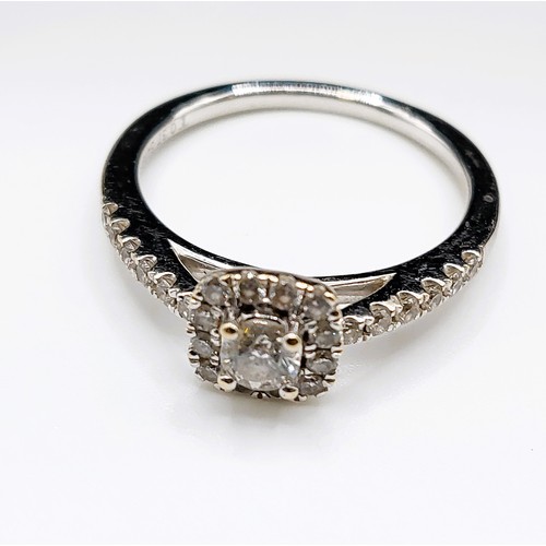 389 - An 18ct white gold and diamond engagement ring, centred with a round brilliant-cut diamond of approx... 