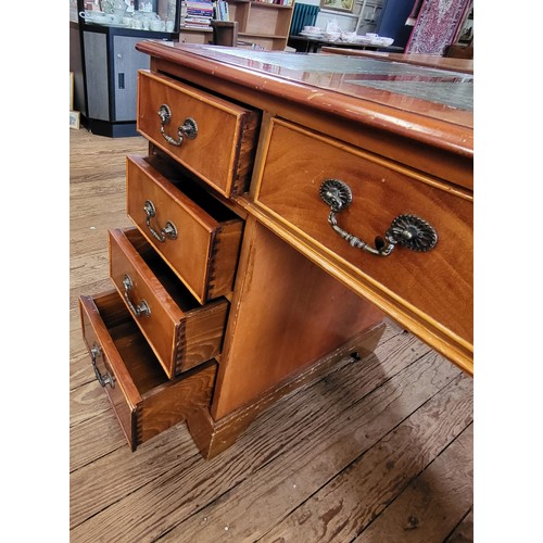 5 - A wooden pedestal desk, with green leather top, in three parts. Left cabinet has three drawers, righ... 