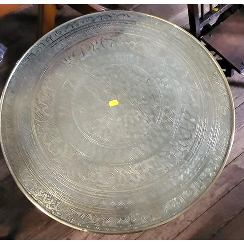 13 - An Egyptian brass table top with barley twist legs, together with an oak child's chair. (2)