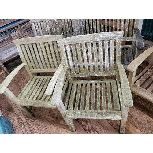 17 - A wooden garden bench 162cm (w), together with four matching chairs.