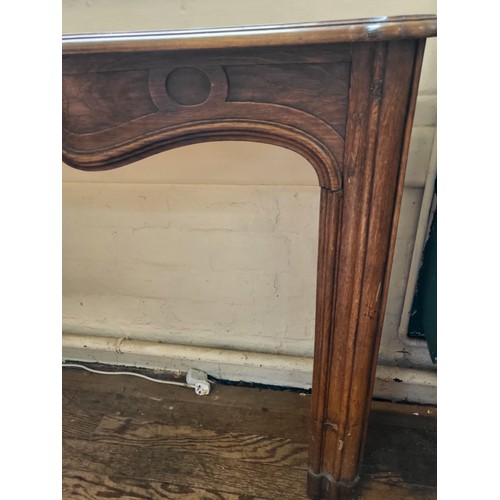 26 - An antique style oak serpentine fire surround, 107cm x 143cm x 33cm.