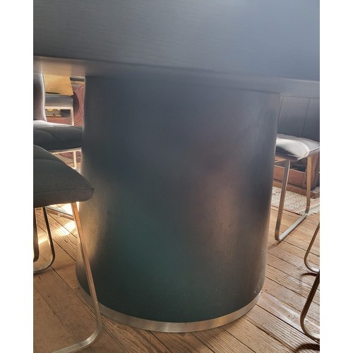 30 - An unusual large black circular table with a tempered glass lazy susan insert, on a circular pedesta... 