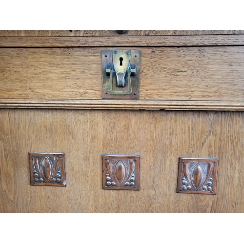 33 - A large Arts and Crafts oak dresser, having glazed cupboards over turned column supports, dresser ba... 