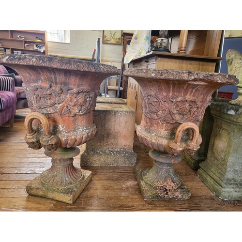 44 - A pair of large red stone campagna shaped urns (80cm x 66cm), with everted rims and twin handles, su... 