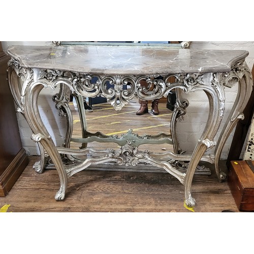 48 - A large mirrored console table, in French Baroque style, with marble top and silver painted wooden l... 