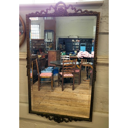 62 - A group of five mirrors: a decorated gilt framed and bevelled mirror 68cm x 55cm, a small oval  wood... 