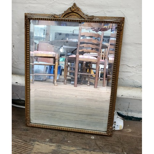 62 - A group of five mirrors: a decorated gilt framed and bevelled mirror 68cm x 55cm, a small oval  wood... 