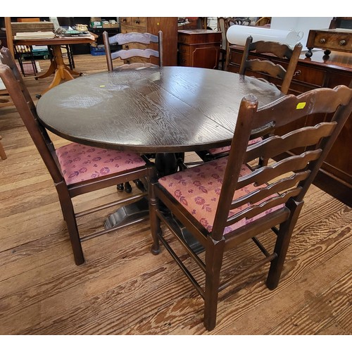 63 - A circular dining table and four ladder-bark dining chairs with red upholstery. Table measures 73cm ... 