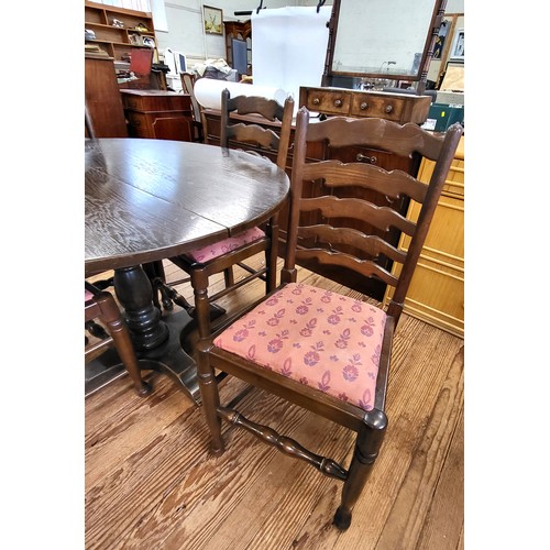 63 - A circular dining table and four ladder-bark dining chairs with red upholstery. Table measures 73cm ... 