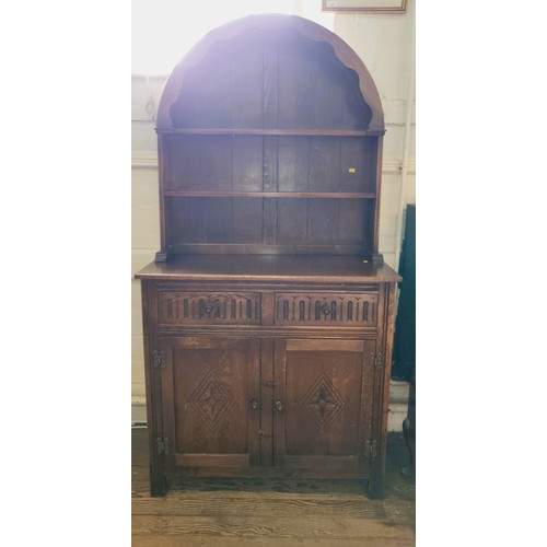 64 - A mahogany dresser with curved top and shelves, two drawers over two doors. 178cm x 92cm