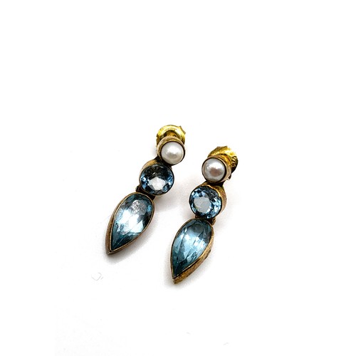 336 - A pair of silver gilt, blue topaz and pearl drop earrings, the articulated mounts set with pear-cut ... 