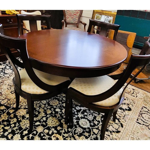 71A - A circular extendable reproduction table and four chairs, table is 112cm with a single centre stand ... 